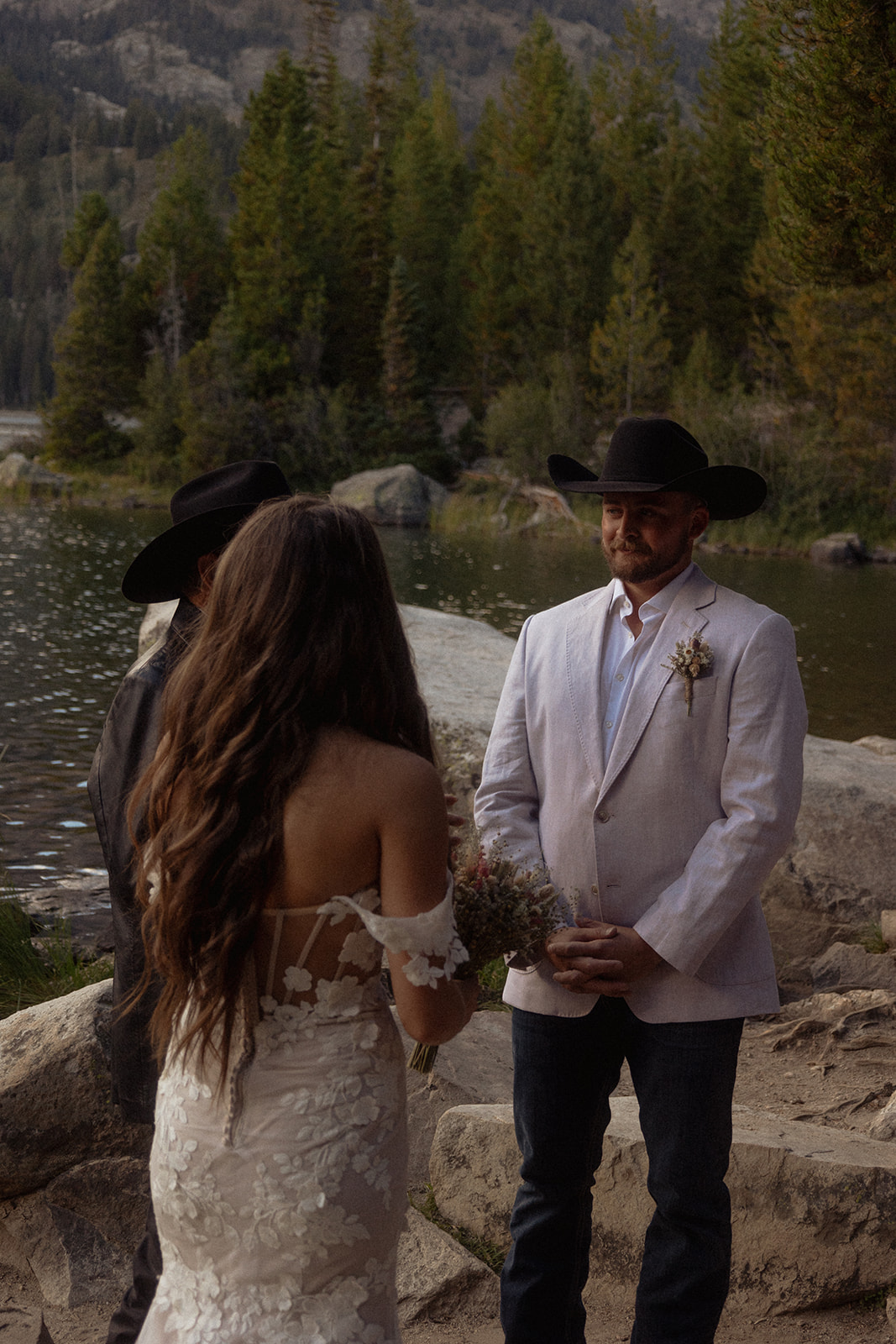 A group of people standing on taggart lake for an Grand Teton National park elopement ceremony