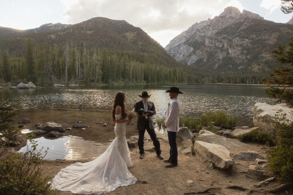 A group of people standing on taggart lake for an elopement ceremony