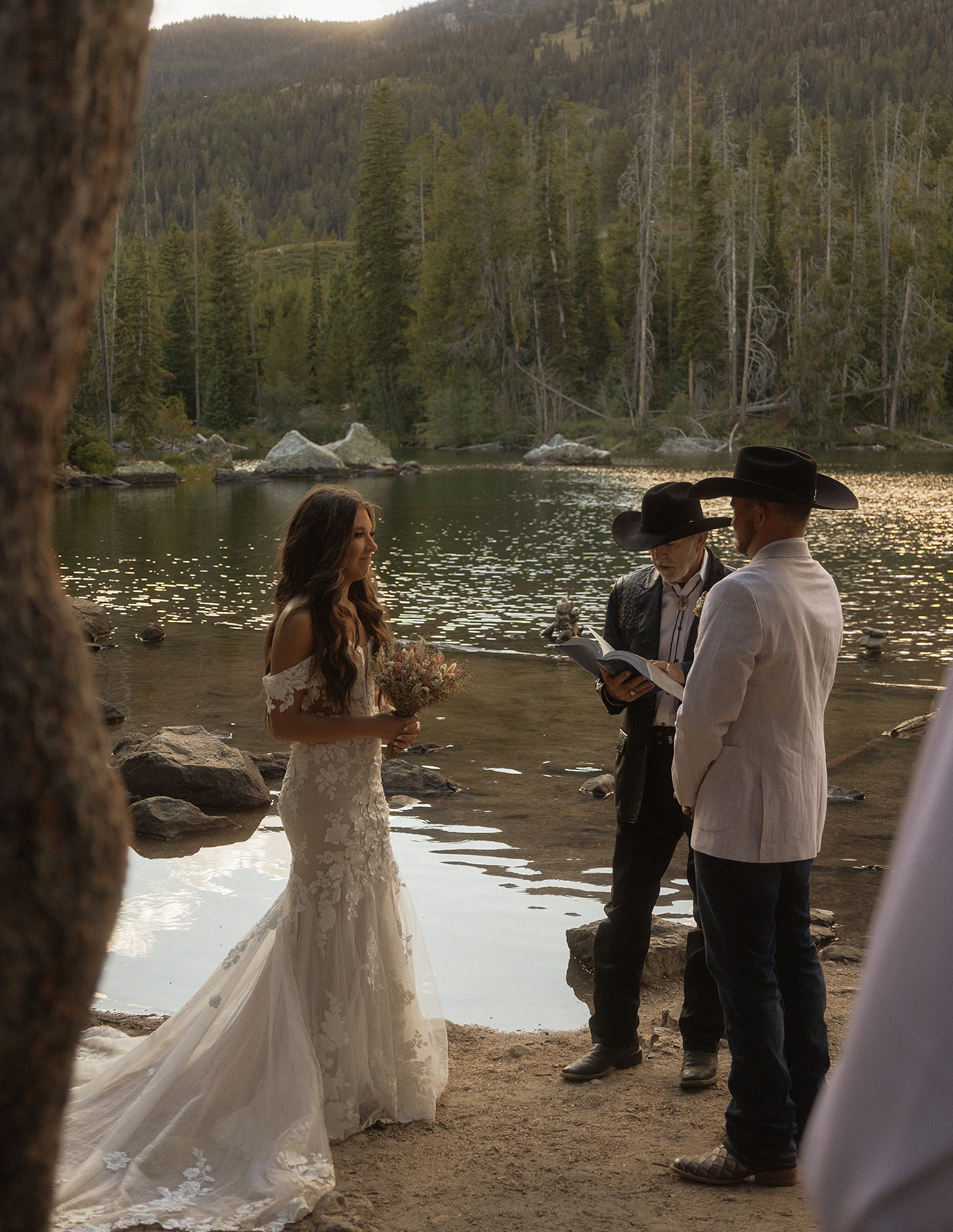 A group of people standing on taggart lake for an Grand Teton National park elopement ceremony 