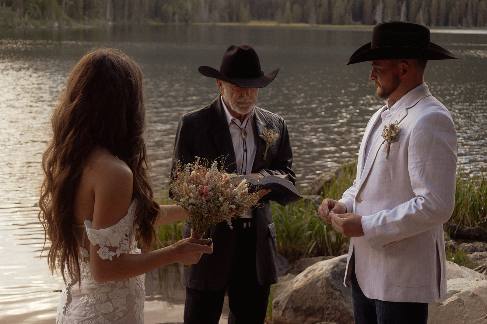 A group of people standing on taggart lake for an Grand Teton National park elopement ceremony 