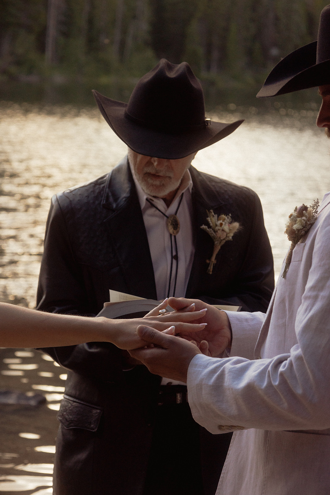 A group of people standing on taggart lake for an Grand Teton National park elopement ceremony 