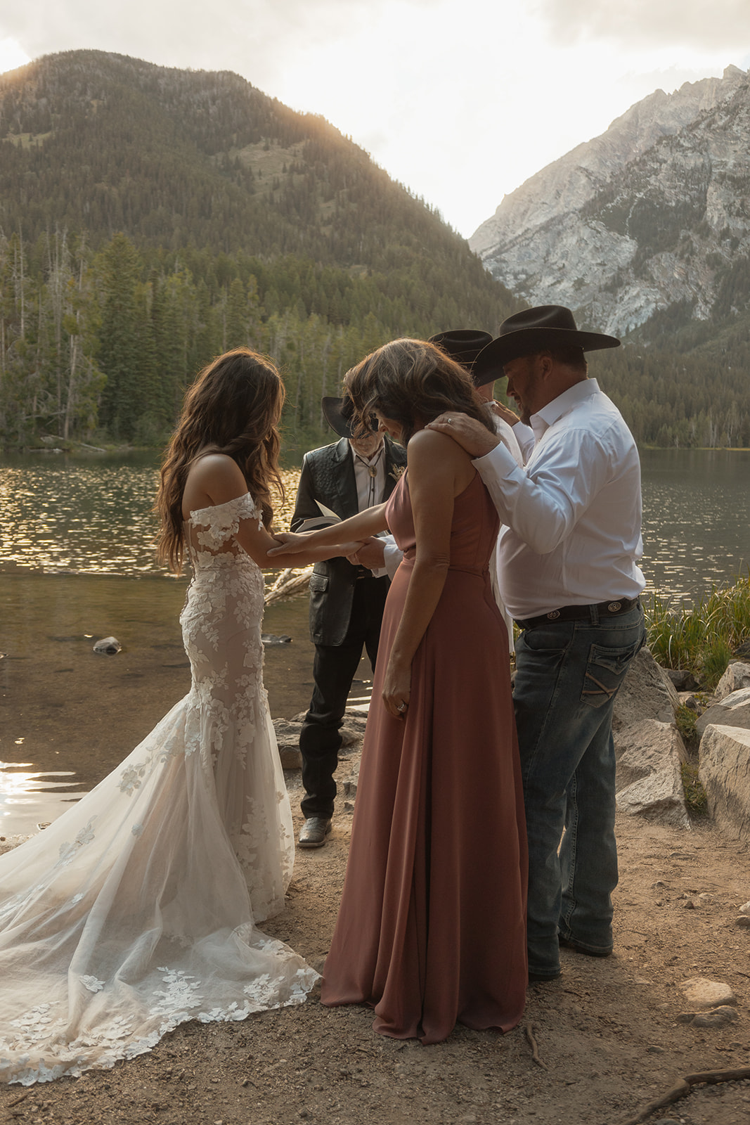 A group of people standing on taggart lake for an Grand Teton National park elopement ceremony